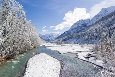 Eng valley in winter. Snow covered landscape with the Riss creek flowing through. Some hoar frosted