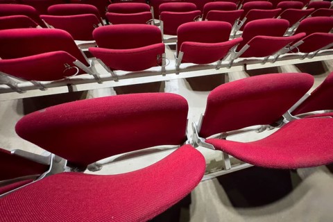 Empty folded-up seats Folding chairs with backrests in rows of seats mounted next to each other