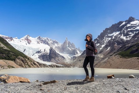 Young woman in front of Mount Cerro Torre, Laguna Torre Trail, El Chaltén, Santa Cruz Province,