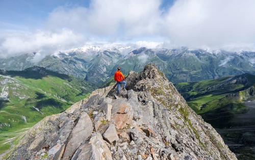 Mountaineer on the summit of Lasörling, view of the mountain panorama of the Venediger Group,