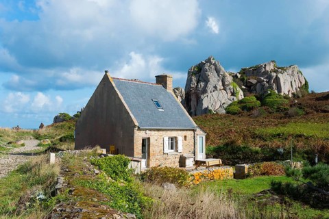 Lonely house in a rural landscape with rocks under a cloudy sky, Plage de Pors Scaff, Plougrescant,