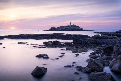 Godrevy Lighthouse, the lighthouse of Godrevy on Godrevy Island. In the evening at sunset. Long