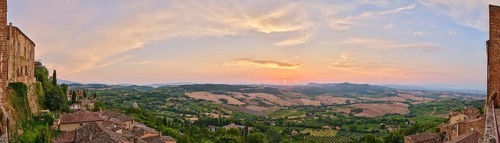 View from Montepulciano into a typical Tuscan landscape in Val d'Orcia with hills, trees, fields,