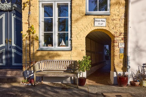 Historic building, Donats Gang, bench, flower pots with plants, street An der Obertrave, Old Town,