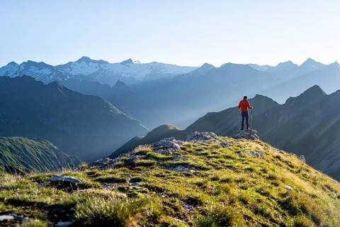 Hiker enjoying the mountain panorama in the morning, Venediger group, behind Dreiherrenkopf,