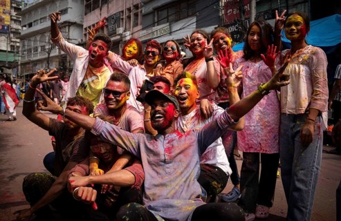 Revellers smear with Gulal or coloured powder and dance to play Holi, the Hindu spring festival of