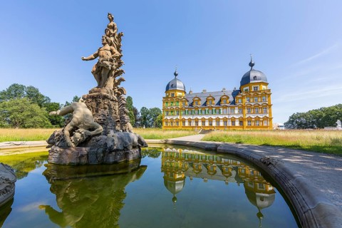 Park view of Seehof Castle with reflection in a water basin of the cascade, Hercules Group by