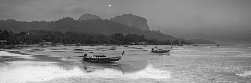 Before sunrise, longtail boats lie at low tide in the harbour at Sivalai Beach, Koh Mook Island,