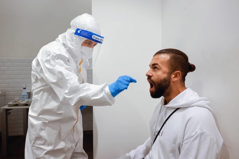 Cologne, North Rhine-Westphalia, Germany - Covid rapid test at the Medicare test centre, throat