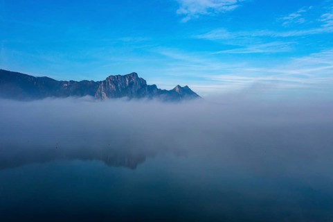 Drone shot, morning fog at Mondsee in autumn with Drachenwand, Salzkammergut, Upper Austria,