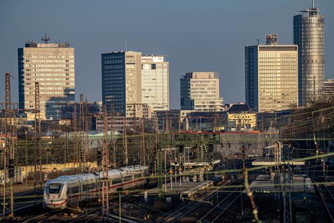 ICE train on the tracks west of Essen central station, skyline of the city centre, North