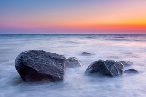 Large boulders in surf at Brodtener Ufer, Brodten Steilufer, cliff in the Bay of Lübeck along the