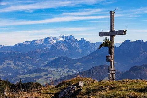 Old summit cross on the Schwarzer Berg with a view of the Lammertal valley and Dachstein massif,