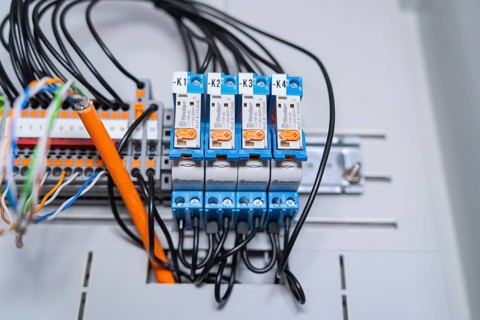 Functional arrangement of blue relays, wired in an electrical system, precise technology visible,