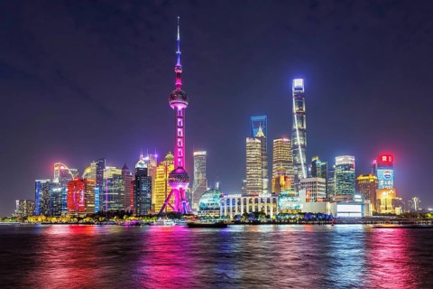 Shanghai skyline at the Bund with Oriental Pearl Tower city centre downtown Pudong at night in