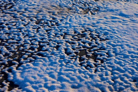 Frozen snow layer with irregular patterns in sunlight, winter, Wasserkuppe, Gersfeld, Rhön, Hesse,