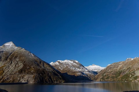 Kölnbrein reservoir and the Oberlecherspitzen mountain on a bright sunny morning. Seen from the