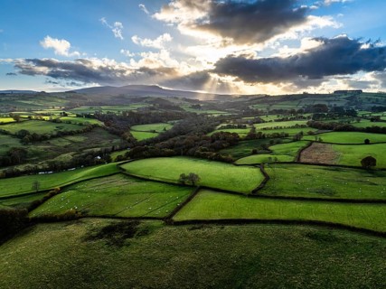 Farms over Trecastle from a drone at sunset, Brecon Beacons National Park, Powys, Wales, England,