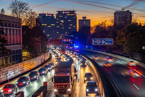 Evening traffic, partly with traffic jams, slow-moving traffic on the A40 motorway, Essen skyline,