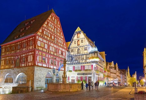 Half-timbered houses in the Herrngasse in the old town of Rothenburg ob der Tauber, illuminated at