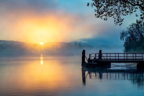 Sunrise, autumnal atmosphere at Lake Baldeney, landing stage for lake cruise boats of the White