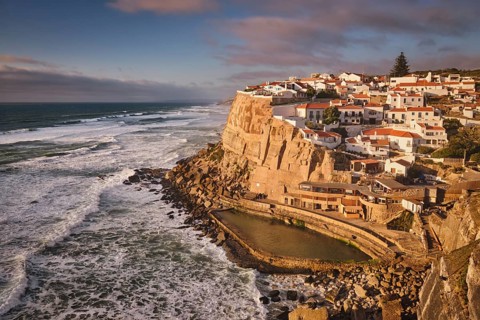 Scenic view of the seaside Azenhas do Mar fishing village on cliff on Atlantic ocean coast,