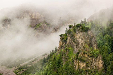 Wisps of mist cover the Karwendel mountains in the Großer Ahornboden nature reserve, Eng Valley,