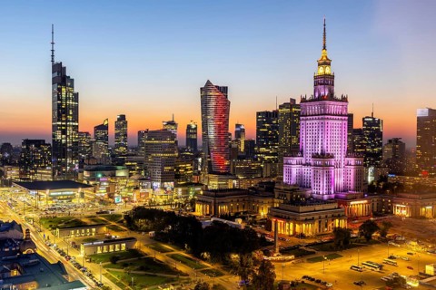 Warsaw skyline skyscrapers with Palace of Culture in the city centre at night in Warsaw, Poland,