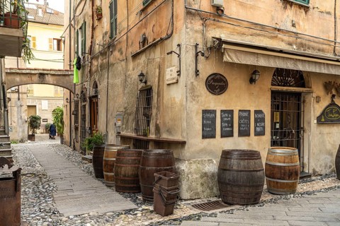 Old wooden barrels from a restaurant in the historic centre of Finalborgo, Finale Ligure, Riviera