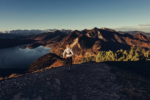 Trail running in autumn on the Jochberg on Lake Walchensee against the wonderful backdrop of the