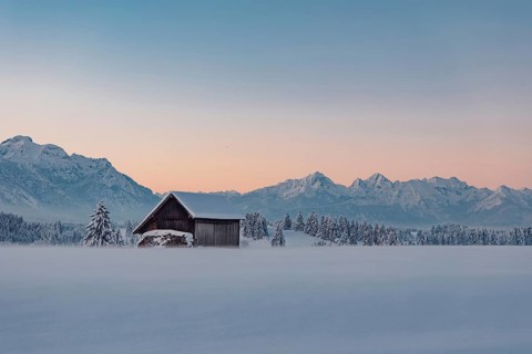 Deep snowy winter morning mood near Halblech in the foothills of the Alps in the Allgäu with the