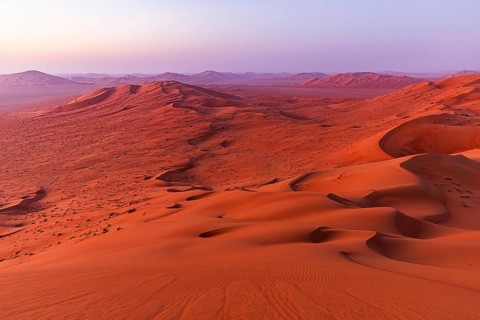 Wind-sculpted, curved sand dunes in the Rub al Khali desert, Dhofar province, Arabian Peninsula,