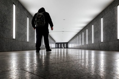 A man walks through the tunnel subway illuminated with LED light to the underground station Museum