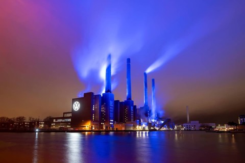 Illuminated cogeneration plant of Volkswagen, Volkswagen logo, the sky is bathed in blue,