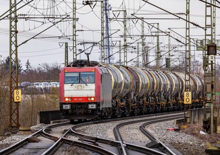 Goods train travelling on the winding Schuster Railway, overhead lines and infrastructure. Tank