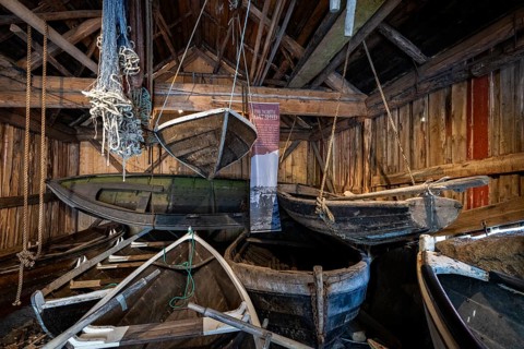 Old fishing boats in a shed, fishing village Nusfjord, Lofoten, Norway, Europe