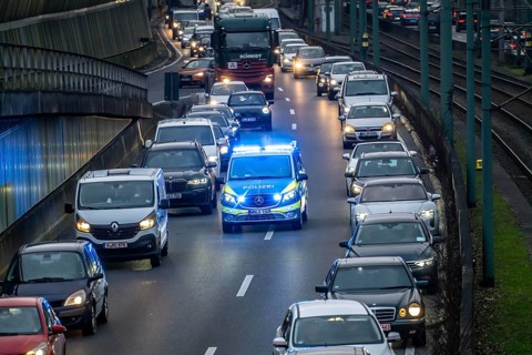 Traffic jam on the A40 motorway, emergency lane, vehicles on the left and right, police patrol car