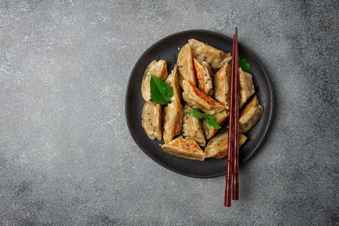 Japanese fried dumplings, gyoza, sesame seeds, top view, no people