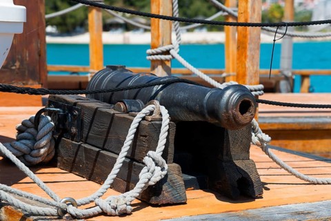 Detailed view of an old cannon on board a wooden ship with maritime elements, Ship Galija, Amadria