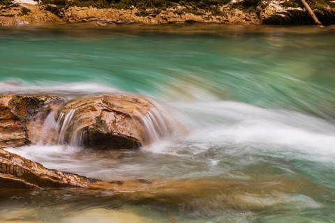 The Riss creek flowing through an autumnal landscape in the Eng valley