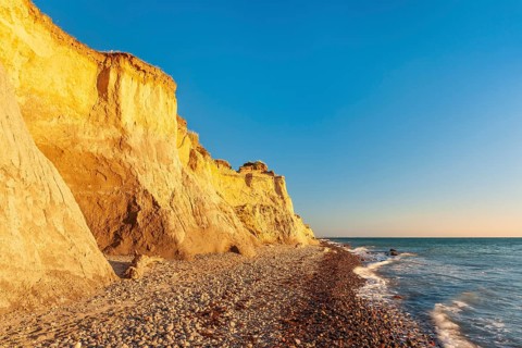 The high shore in the evening light, beach with pebbles, steep coast near Ahrenshoop,