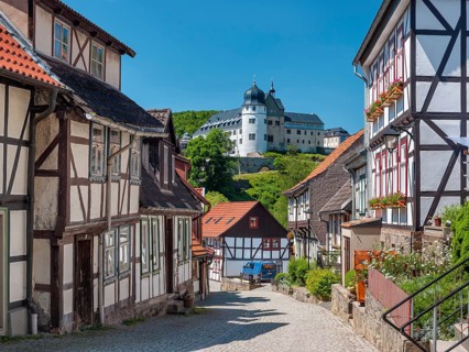 Street with half-timbered houses and cobblestones in the historic old town, behind the castle,