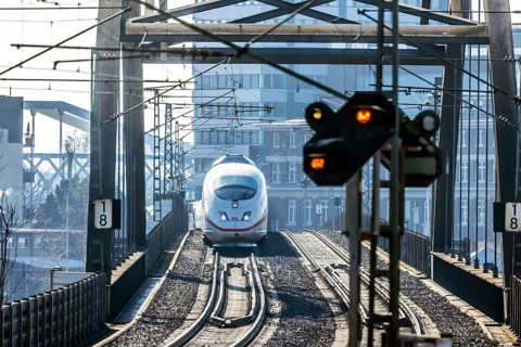 ICE en route on a railway bridge with tracks and signalling system. Mannheim, Baden-Württemberg,