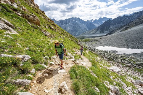 Mountaineer on a hiking trail, mountain landscape near Arolla, ascent to Col de Riedmatten, Valais,