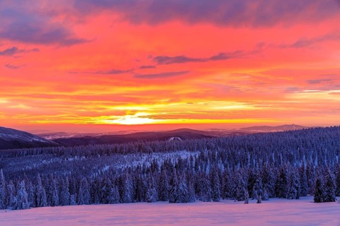 Sunset on a winter evening at the Wossecker Baude above Harrachsdorf in the Giant Mountains, in the