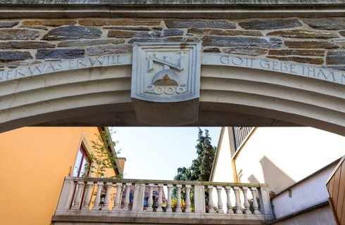 Architectural combination of old and new, keystone with initials and sandstone railing of a terrace