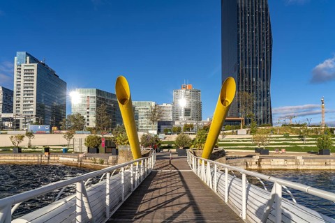 Pontoon bridge Ponte Cagrana and the skyline of Donau City in Vienna, Austria, Europe