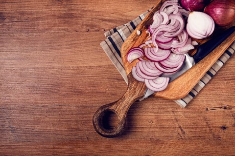 Sliced red onion, on a chopping board, with a knife, Spanish onion, raw onion, close-up, top view