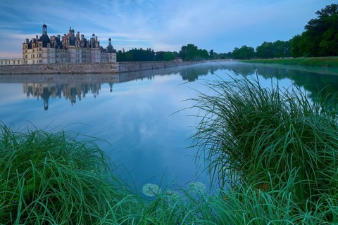 Chambord Castle with moat at sunrise, Chambord, Department Loir-et-Cher, Centre region, France,