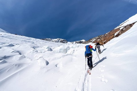 Ski tourers on an alpine tour on the Fürkeleferner glacier, snow-covered mountain landscape in